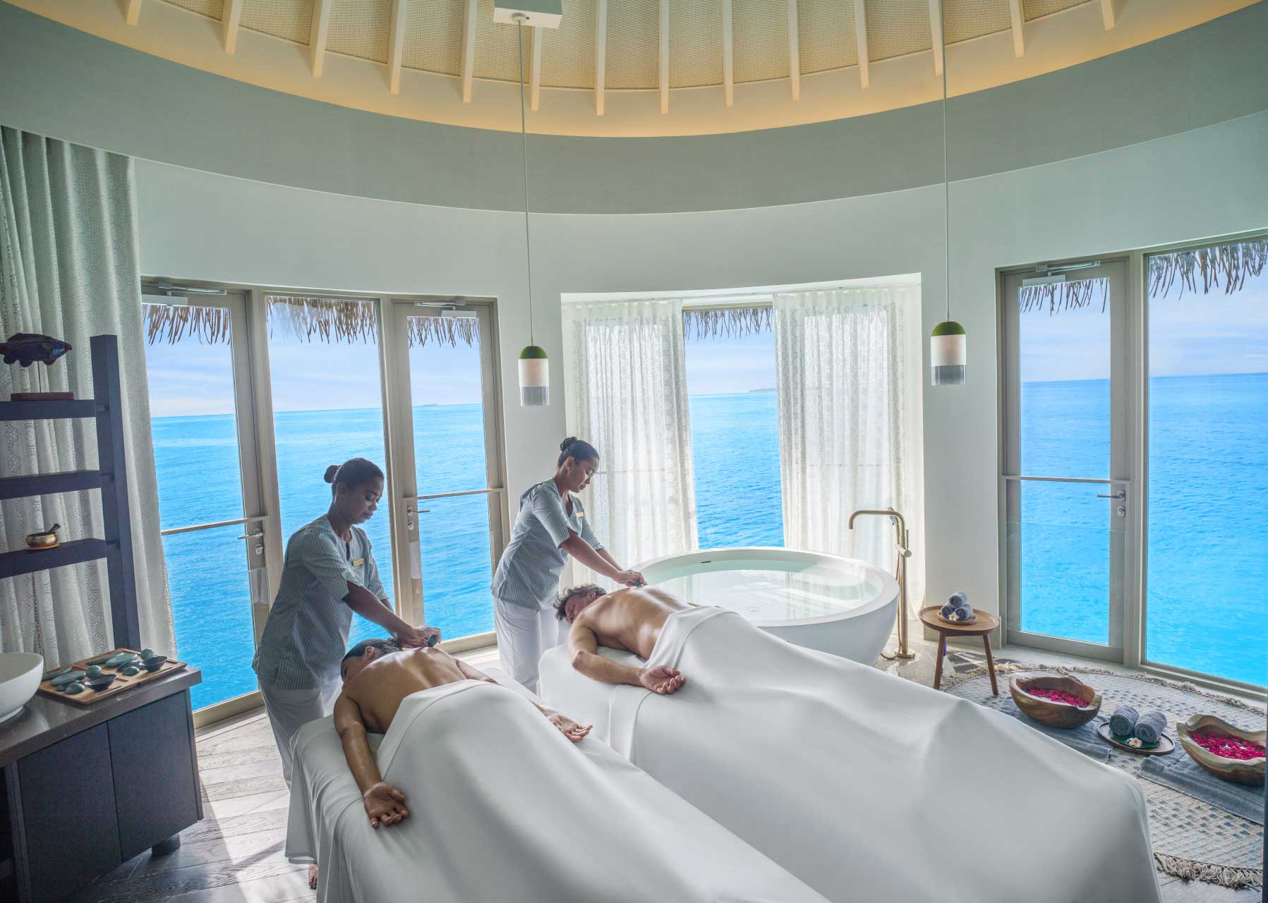 Couple receiving a massage at the AVI spa at intercontinental maldives